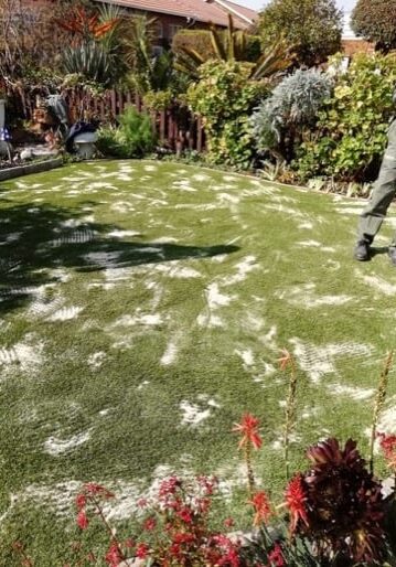 applying silica sand infill during artificial grass installation