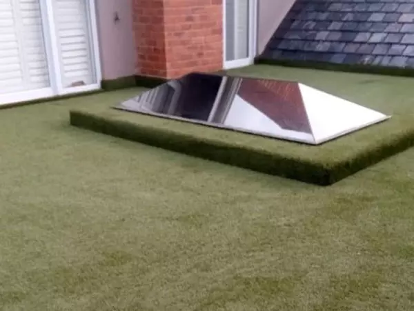 a balcony with artificial grass covering the entire balcony