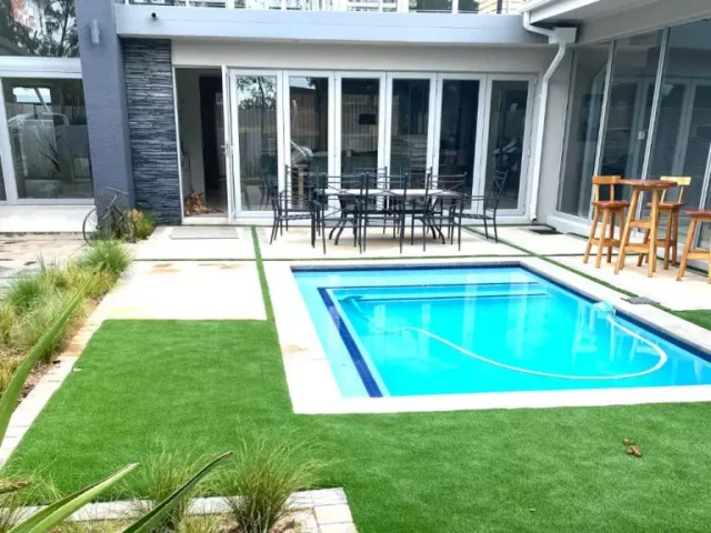 a pool area with artificial grass